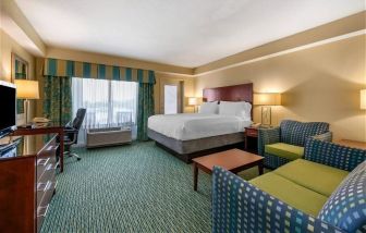 Luxurious king suite with TV, business desk, and lounge area at Holiday Inn Resort Lake Buena Vista.