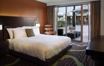 King bedroom with work space and balcony at Hard Rock Hotel San Diego.