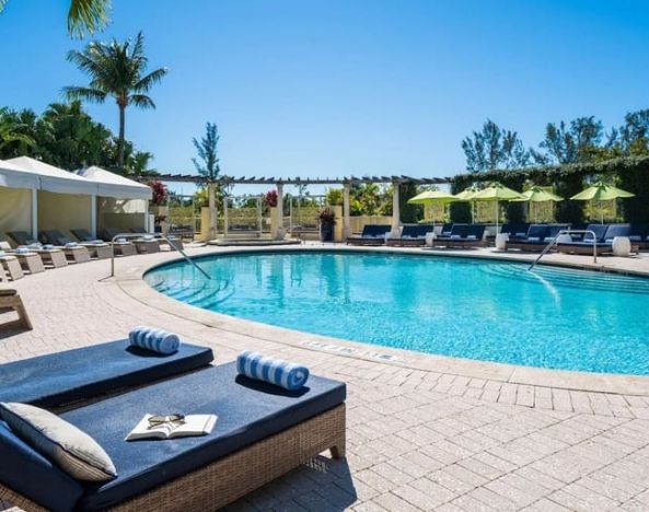 Stunning outdoor pool with sun beds at Naples Grande Beach Resort.