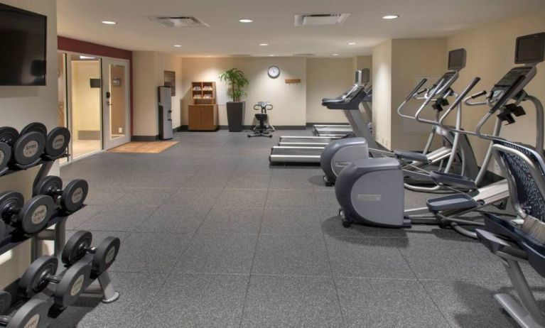 The hotel fitness center, with racks of weights and assorted exercise machinery.