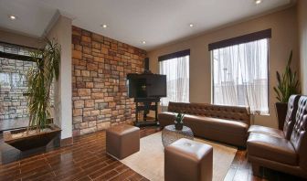 Lounge in the lobby of Best Western Plus Newark Airport, including comfortable seating and sizeable TV.