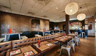 On-site dining at the Best Western Plus Newark Airport’s restaurant, which has small tables and a hard floor.