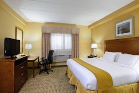 Double bed guest room in Holiday Inn Express Philadelphia Airport, with window and TV set.