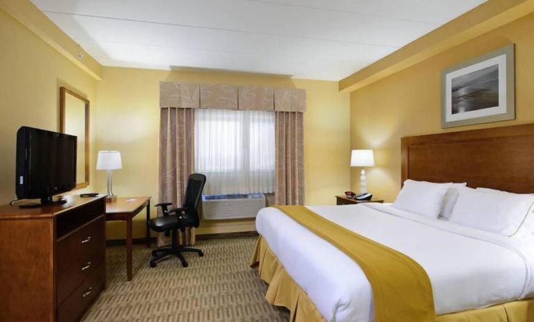 Double bed guest room in Holiday Inn Express Philadelphia Airport, with window and TV set.