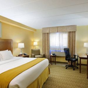 Guest room in Holiday Inn Express Philadelphia Airport, with double bed and chair/desk for working.