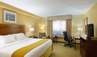 Guest room in Holiday Inn Express Philadelphia Airport, with double bed and chair/desk for working.