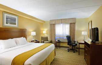 Guest room in Holiday Inn Express Philadelphia Airport, with double bed and chair/desk for working.