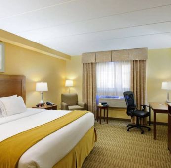 Guest room in Holiday Inn Express Philadelphia Airport, with double bed and chair/desk for working.