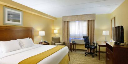 Guest room in Holiday Inn Express Philadelphia Airport, with double bed and chair/desk for working.