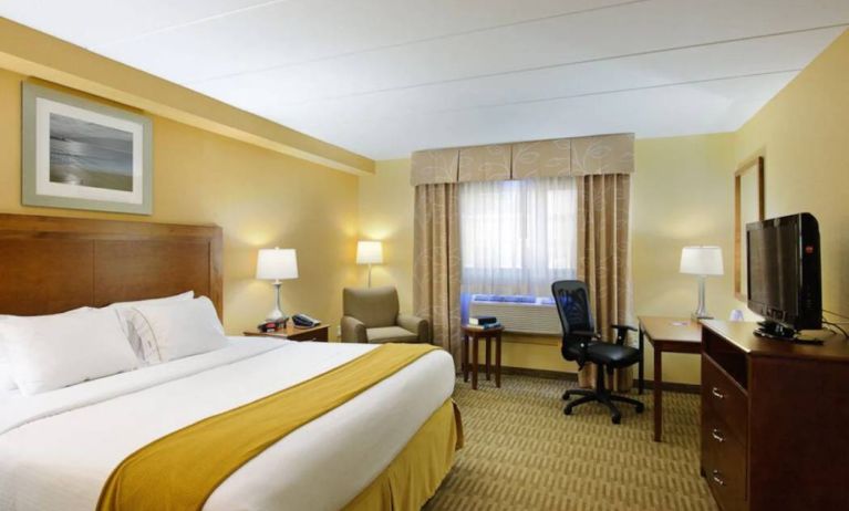 Guest room in Holiday Inn Express Philadelphia Airport, with double bed and chair/desk for working.