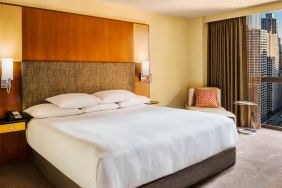 Double bed guest room in Hyatt Regency Chicago, with large window offering views of the urban vista.