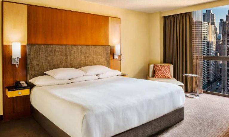 Double bed guest room in Hyatt Regency Chicago, with large window offering views of the urban vista.