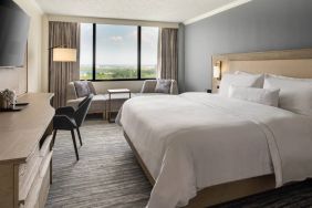 Guest room in the Westin Atlanta Airport Hotel, with large bed and workspace desk and chair.