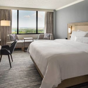 Guest room in the Westin Atlanta Airport Hotel, with large bed and workspace desk and chair.