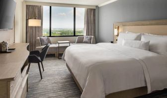 Guest room in the Westin Atlanta Airport Hotel, with large bed and workspace desk and chair.