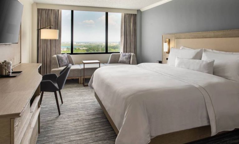 Guest room in the Westin Atlanta Airport Hotel, with large bed and workspace desk and chair.