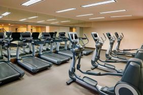 The hotel fitness center is equipped with numerous exercise machines for guests.