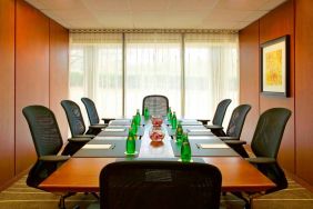 One of Westin Atlanta Airport Hotel’s meeting rooms, with long table, seating for eight, and a large window.