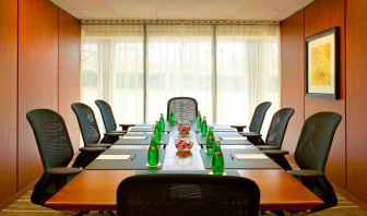 One of Westin Atlanta Airport Hotel’s meeting rooms, with long table, seating for eight, and a large window.