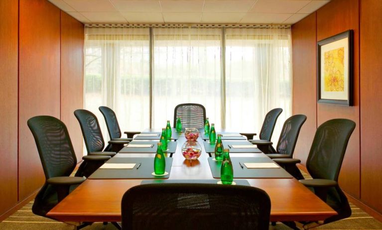 One of Westin Atlanta Airport Hotel’s meeting rooms, with long table, seating for eight, and a large window.