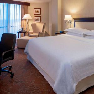 Sheraton Houston Brookhollow Hotel guest room with double bed and a workspace desk and chair.