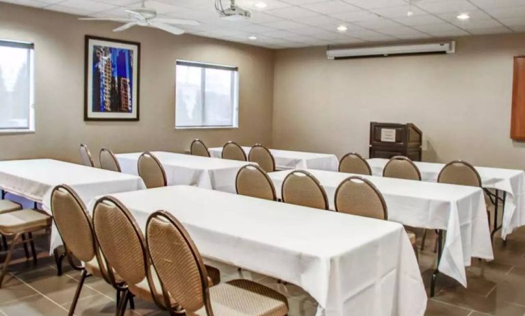 Hotel meeting room with multiple tables arranged facing a lectern.