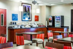 The Comfort Suites Lombard – Addison’s breakfast area has small tables and a hard floor.