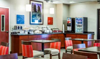 The Comfort Suites Lombard – Addison’s breakfast area has small tables and a hard floor.