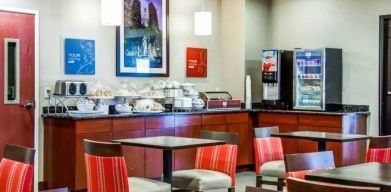 The Comfort Suites Lombard – Addison’s breakfast area has small tables and a hard floor.