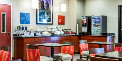 The Comfort Suites Lombard – Addison’s breakfast area has small tables and a hard floor.