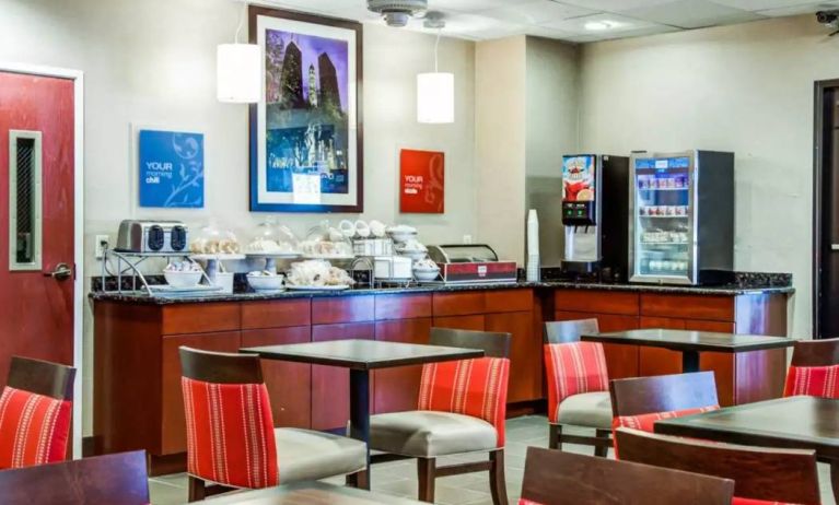 The Comfort Suites Lombard – Addison’s breakfast area has small tables and a hard floor.