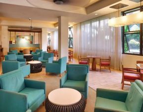 The hotel lounge features comfy chairs and coffee tables.