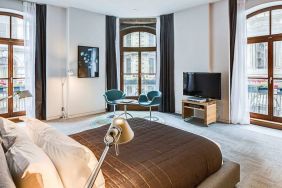 Guest room in Hotel Gault, featuring double bed, widescreen television and large windows.