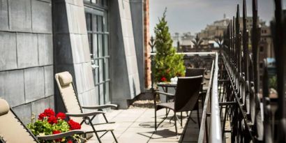 Many of the rooms in Hotel Gault have balconies with chairs and tables.