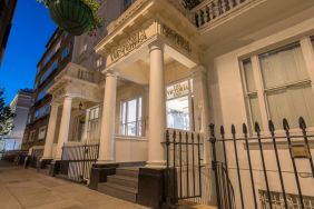 The nocturnal exterior of the Victoria Inn, including stylish white columns.