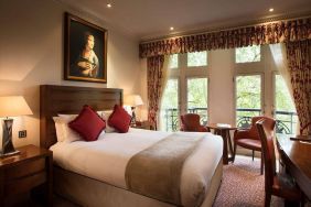 The Royal Horseguards Hotel’s garden view double room, with large windows for a verdant view.