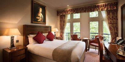 The Royal Horseguards Hotel’s garden view double room, with large windows for a verdant view.