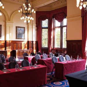 The River Room of The Royal Horseguards Hotel, a meeting space decorated with wood panels and chandeliers.