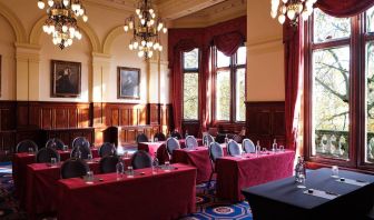 The River Room of The Royal Horseguards Hotel, a meeting space decorated with wood panels and chandeliers.