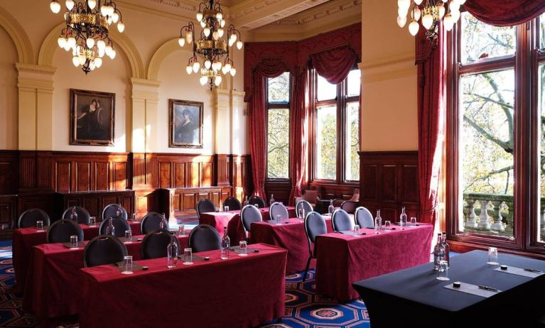 The River Room of The Royal Horseguards Hotel, a meeting space decorated with wood panels and chandeliers.