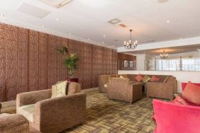 Hotel lounge featuring armchairs and sofas.