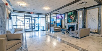 The Quality Inn Halifax Airport’s lobby has numerous comfy sofas, plus a widescreen TV and art on the walls.