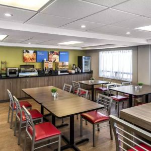 The hotel’s breakfast area has a hard floor and variety of table sizes for diners.