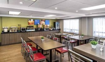 The hotel’s breakfast area has a hard floor and variety of table sizes for diners.