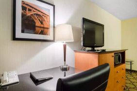 Guest room in the Comfort Inn Saskatoon, with workspace desk and chair and nearby TV.