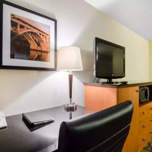 Guest room in the Comfort Inn Saskatoon, with workspace desk and chair and nearby TV.