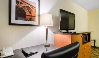 Guest room in the Comfort Inn Saskatoon, with workspace desk and chair and nearby TV.