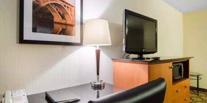 Guest room in the Comfort Inn Saskatoon, with workspace desk and chair and nearby TV.