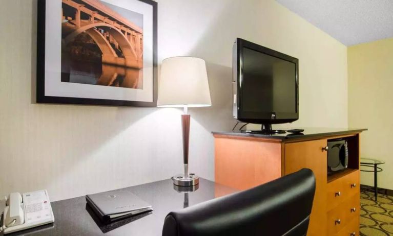 Guest room in the Comfort Inn Saskatoon, with workspace desk and chair and nearby TV.