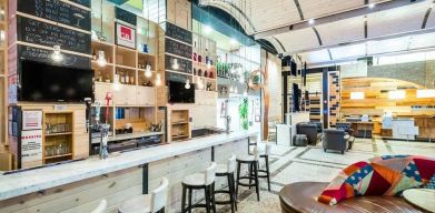 The Gastro Bar of TRYP By Wyndham Times Square South, with both bar stools and soft seats.